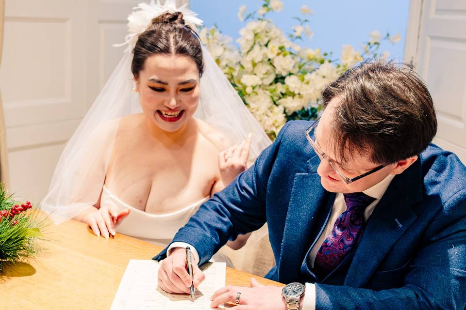 Smiling couple signing contrac