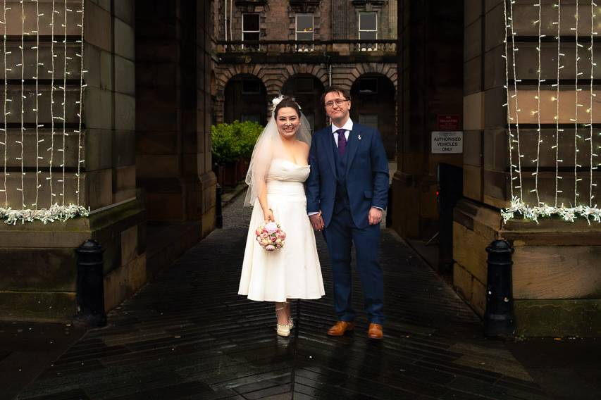 Newly weds under dramatic arch
