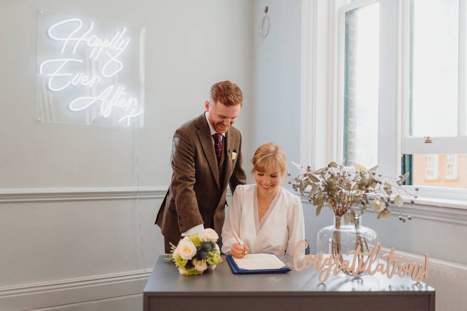 Couple signing the registry