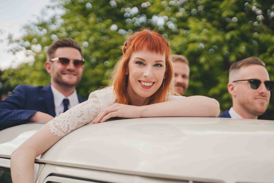 Big smiles on top of car