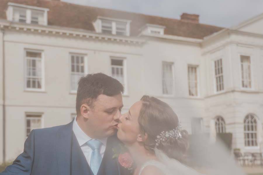 Couple kissing behind veil