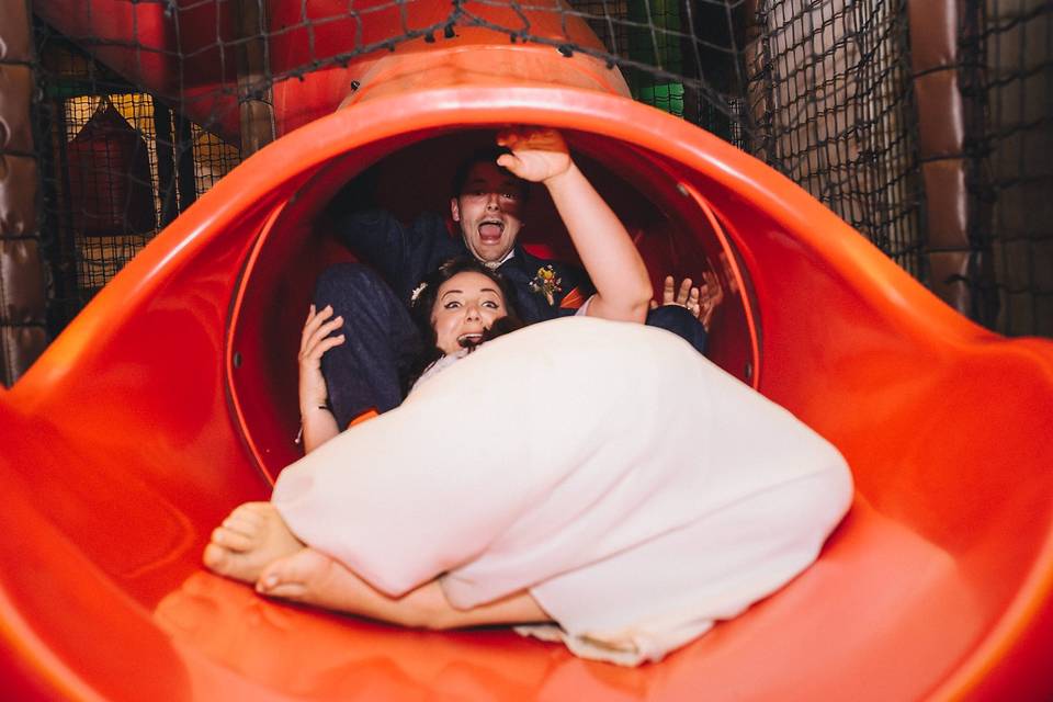 Newlyweds going down a slide