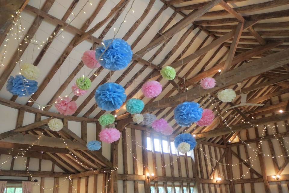 Colourful pompoms hung from the beams.