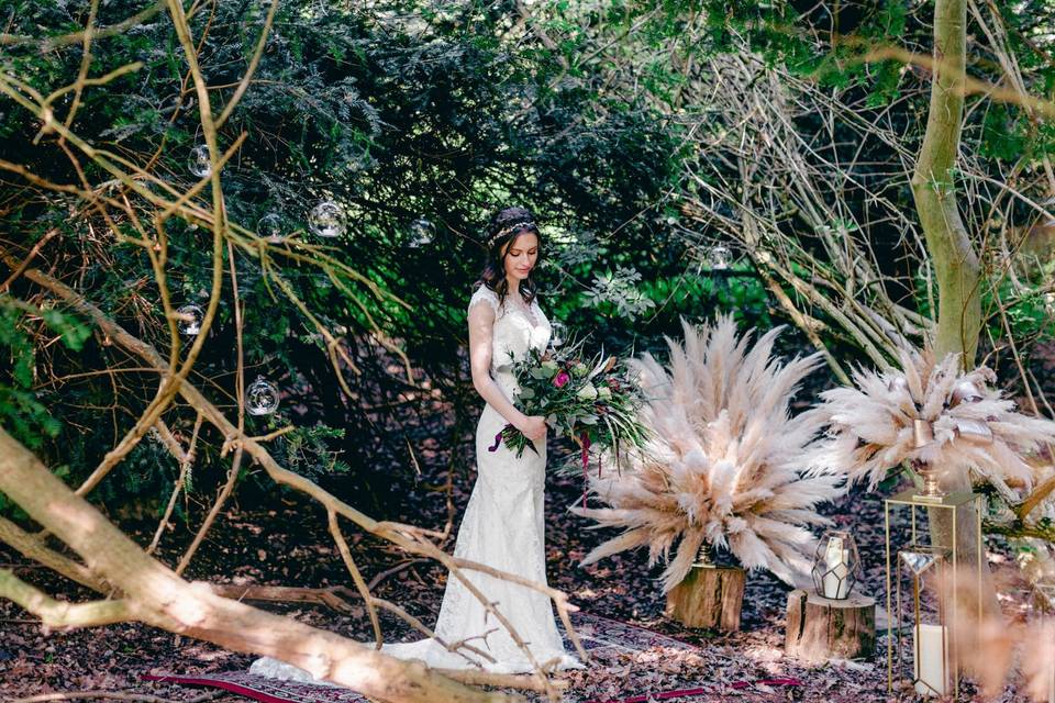 Bride standing among the trees