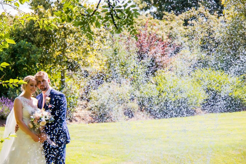 Couple pose in front of pond