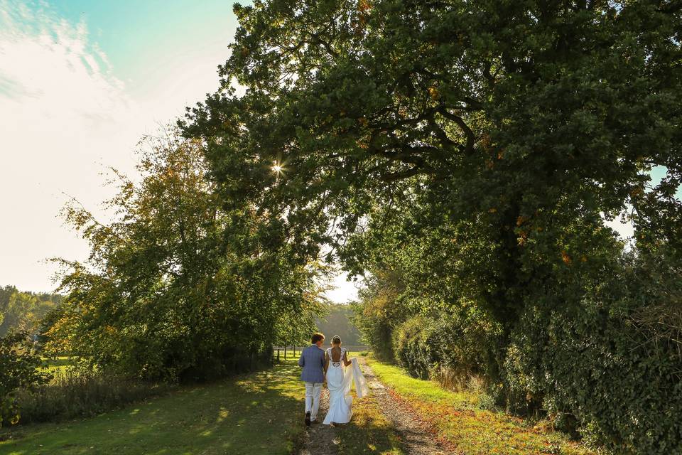 Couple walk in meadow