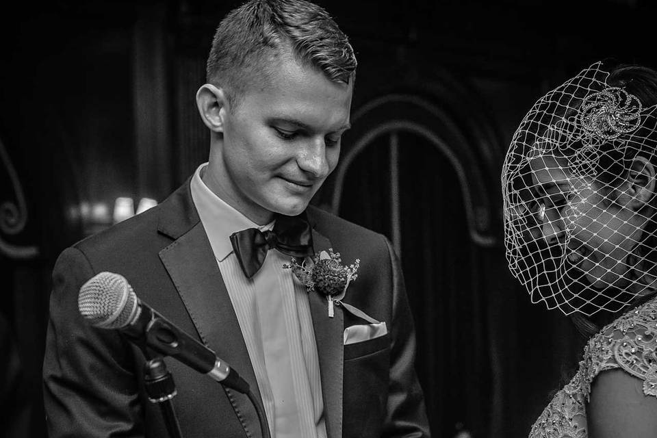 Groom Places Ring on Finger of His Bride