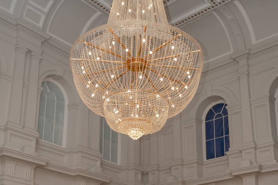 Standing under a chandelier