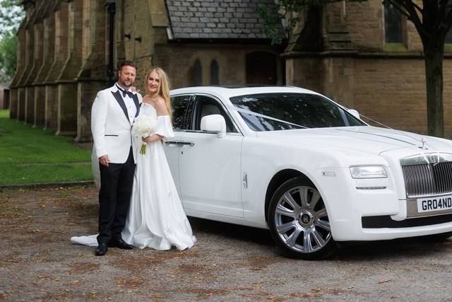 Bride and groom with the car