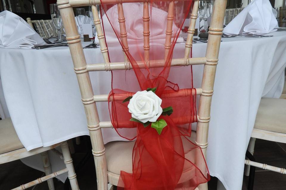 Red chair sash with flower