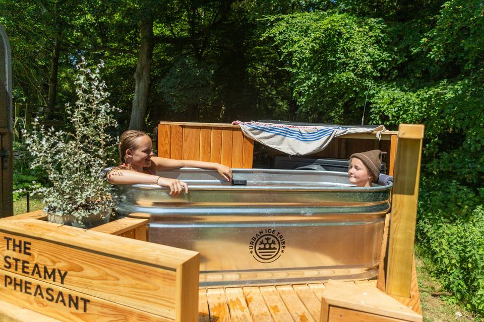Couple in outdoor wooden tub