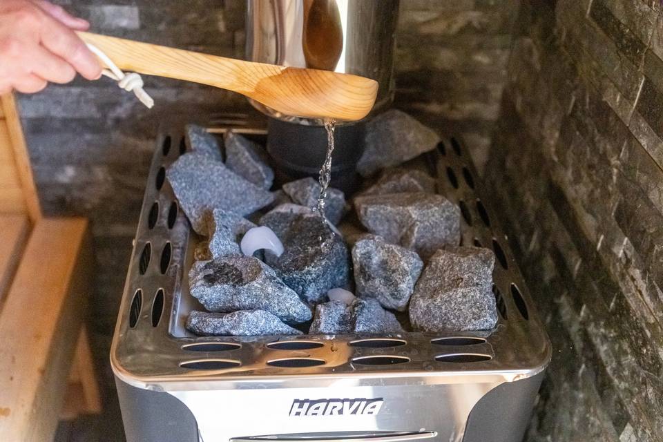 Ladle pouring water on rocks