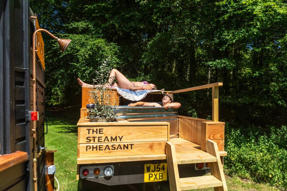 Person relaxing on sauna deck
