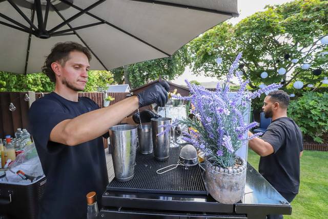 Bartender adding lavender garnish