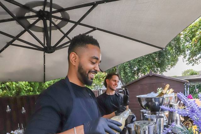 Bartender pouring drink into glass