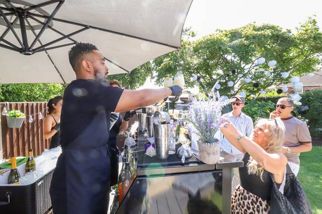 Bartender serving guests outdoors