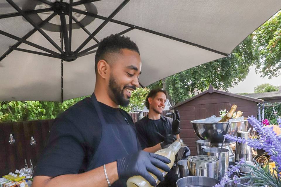 Bartender pouring drink into glass