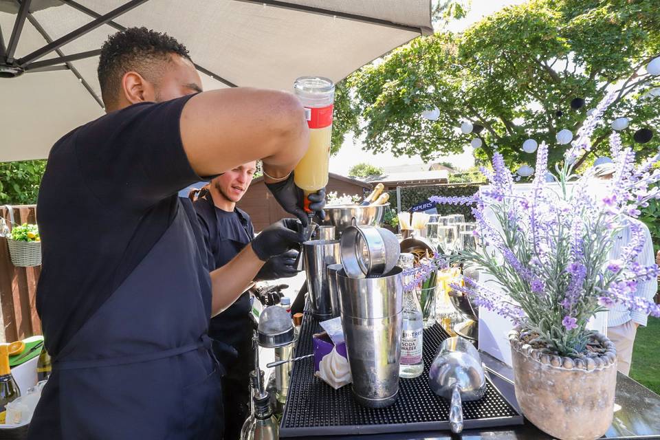 Mixing cocktail behind bar