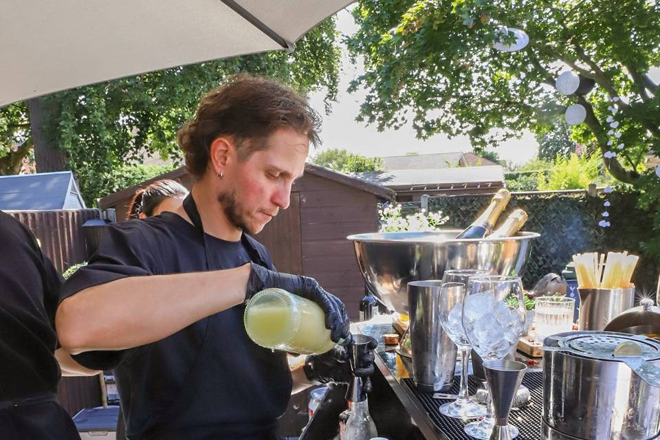 Pouring finished cocktail drink