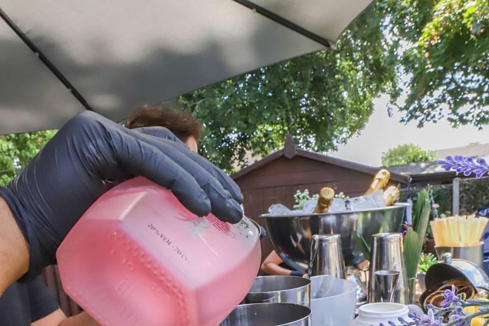 Pouring pink mixer into glass