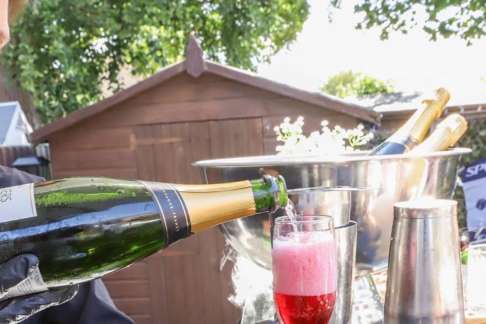 Pouring red cocktail liquid