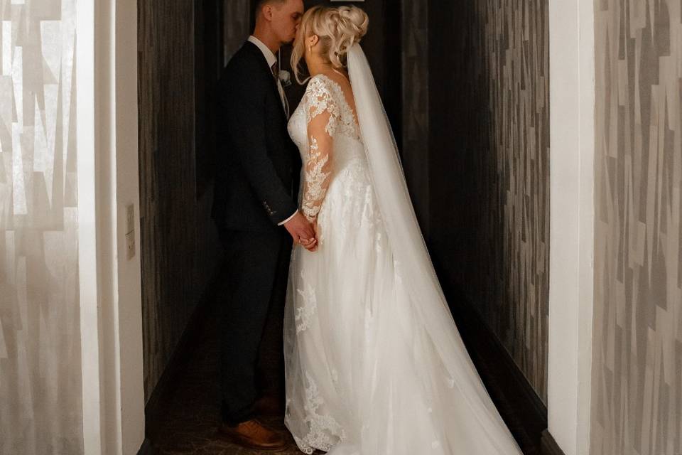 Stealing a kiss in a hallway