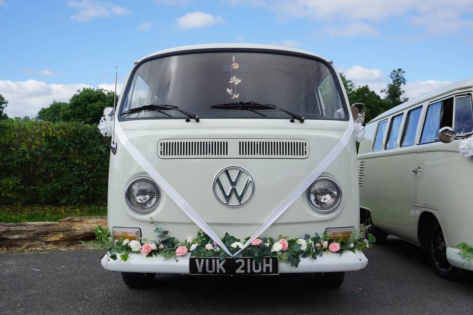 Two pearl white VW camper vans