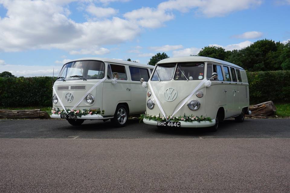 Two pearl white VW camper vans