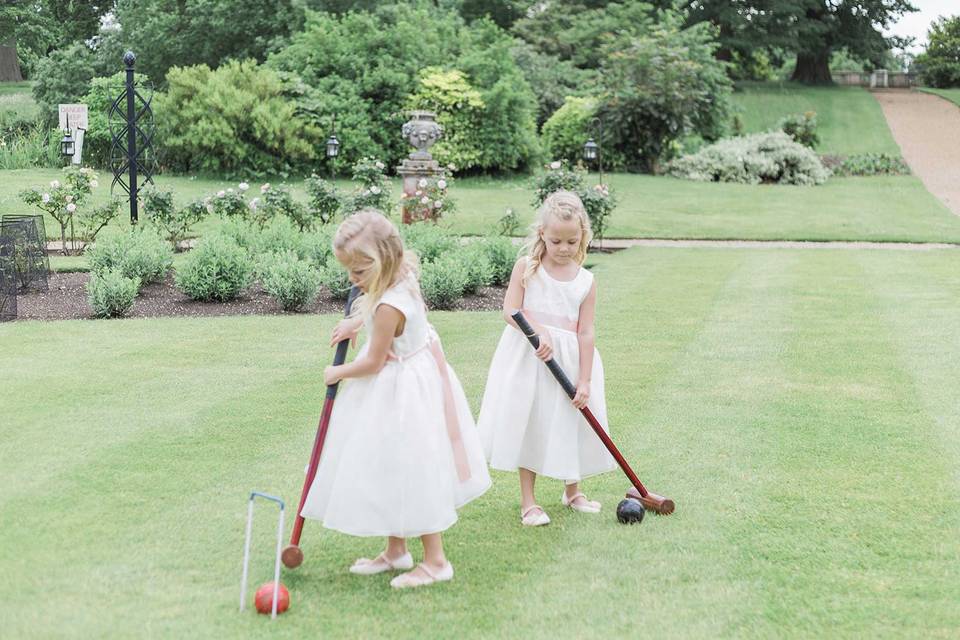 Flower girls playing croquet