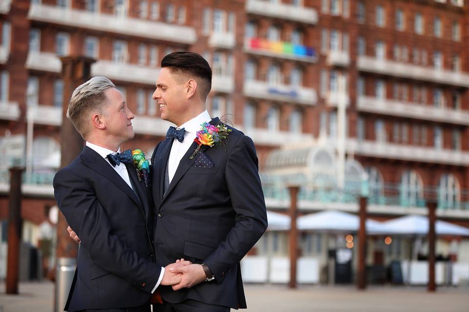Two Grooms outside of Hotel