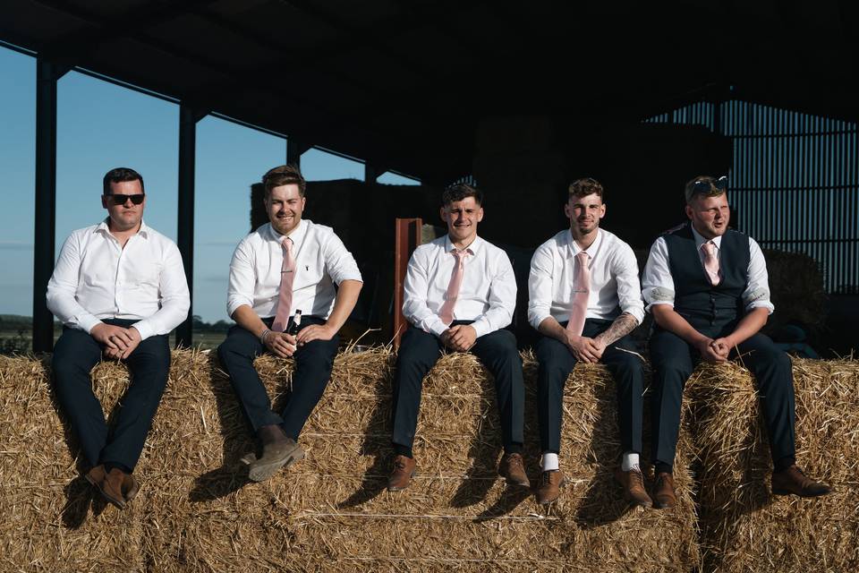 Groomsmen on starwbales