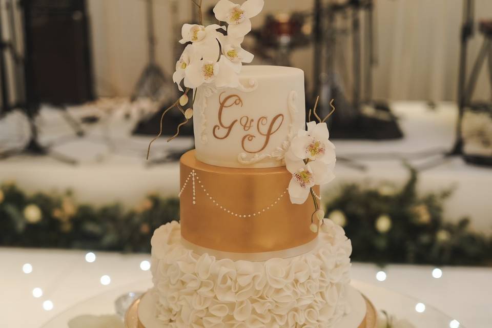 Golden orchids on wedding cake