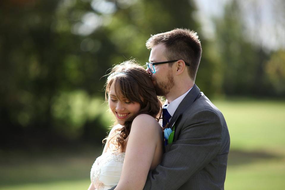 Bride and groom cuddling