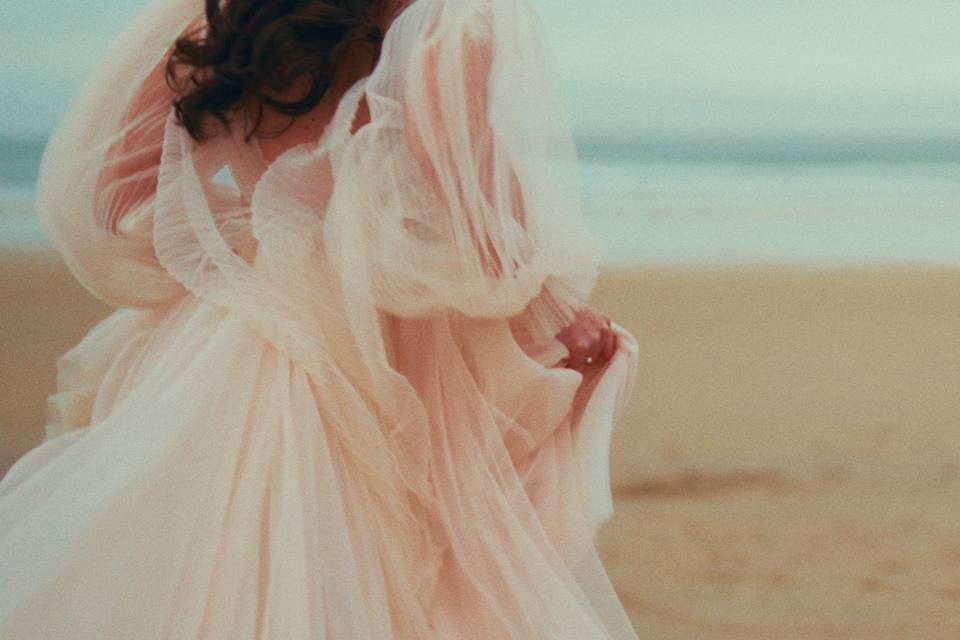 Bride running on the beach