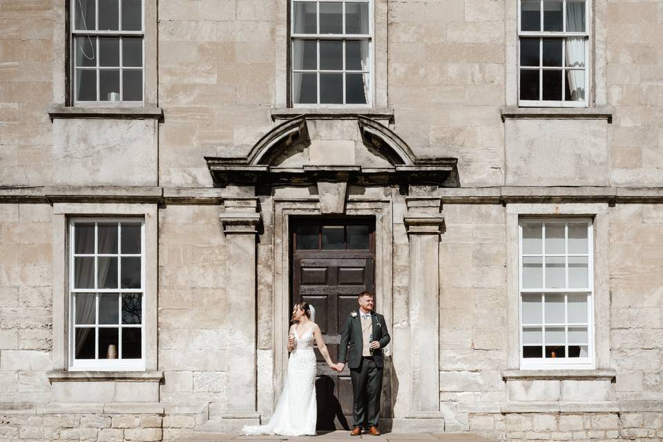 Bride and Groom front of house