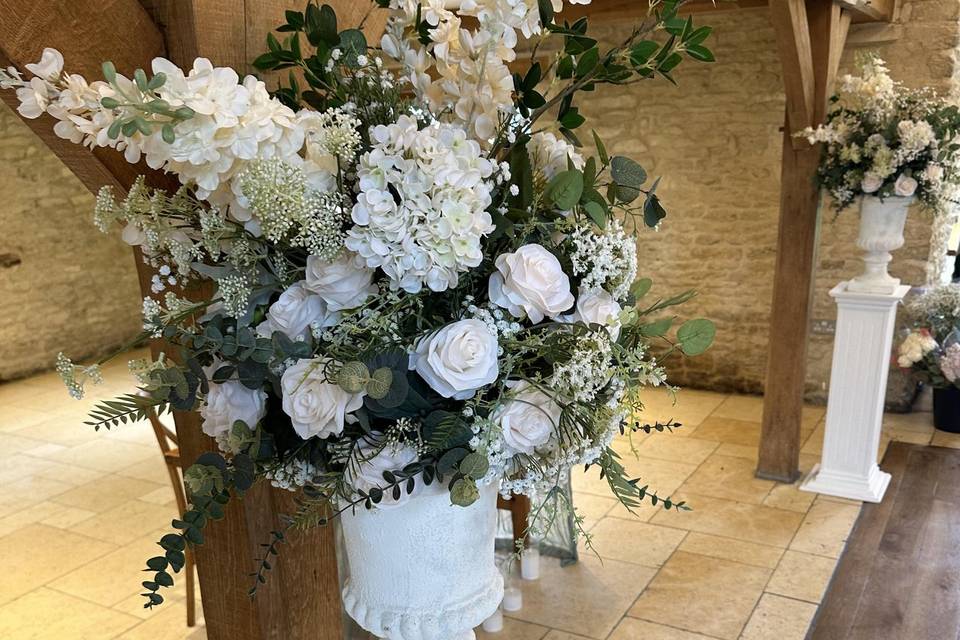 Floral urns on plinths