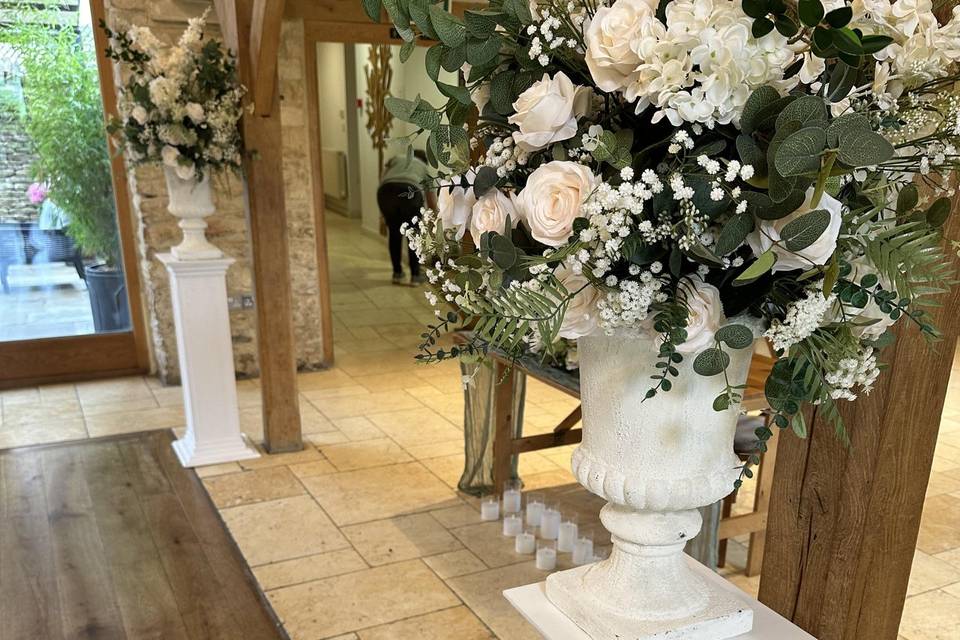 Floral urns on plinths