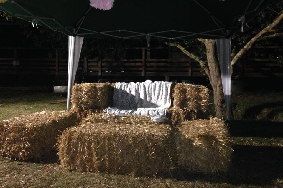 Wedding relaxing on hay bales at Tournerbury