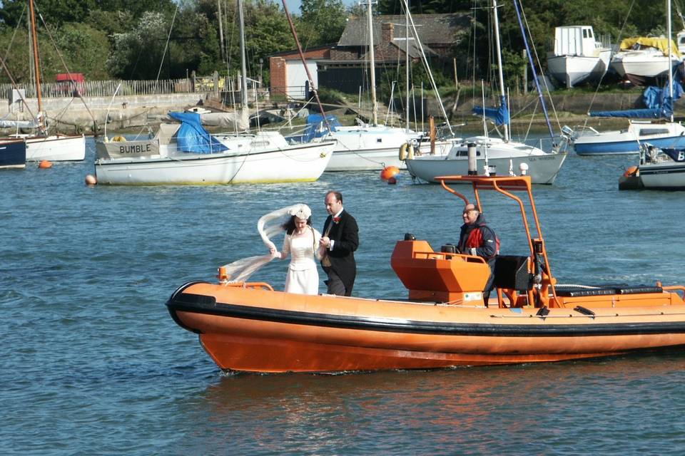 Wedding arrival by boat at Tournerbury