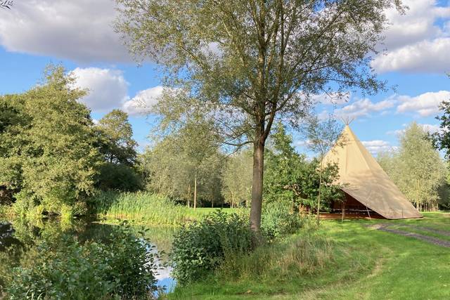 A single tipi by the lake