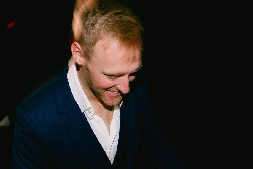 Musician in navy suit DJs