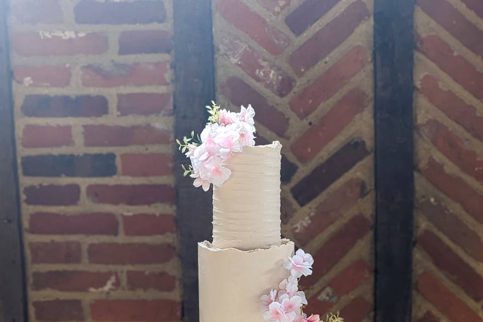 Three tier white and pink wedding cake