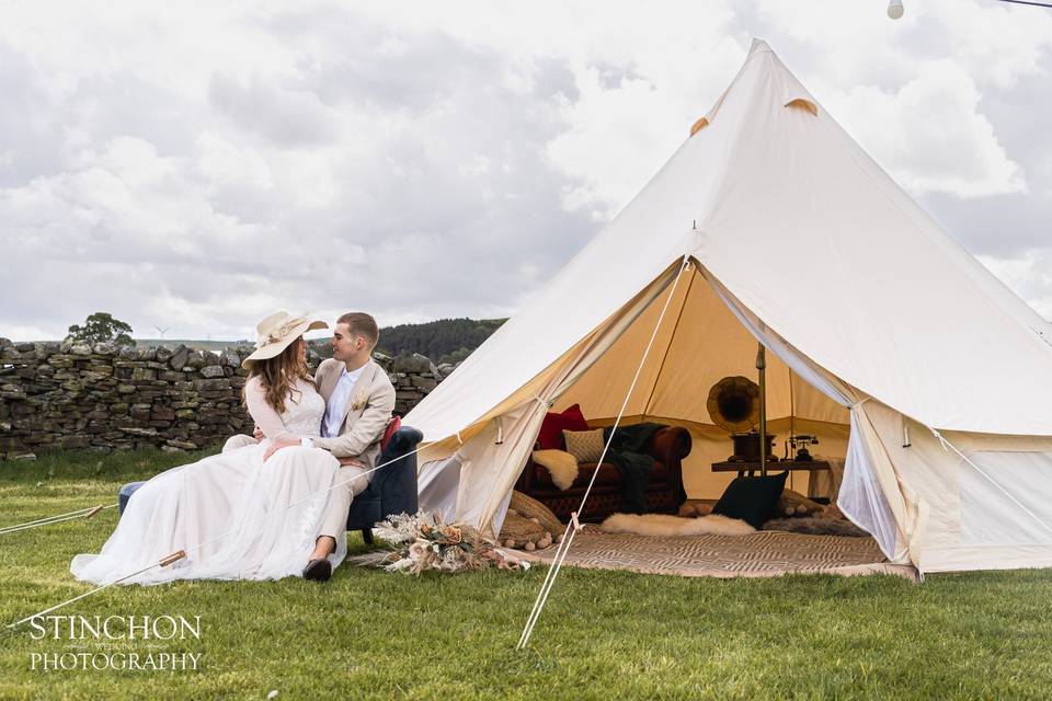 Couple sat outside the tent