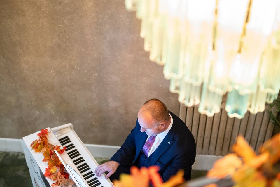 high angle pianist under glass chandelier