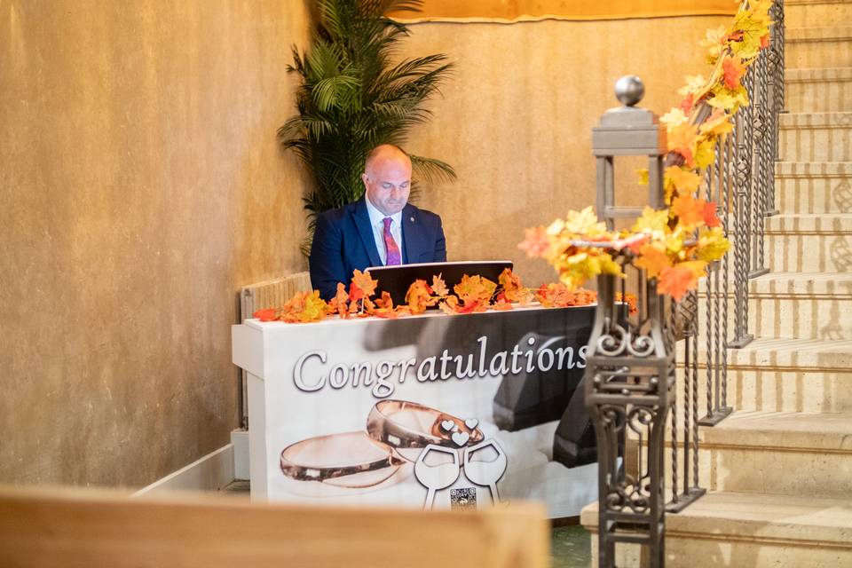 reception dais with autumn foliage and table banner