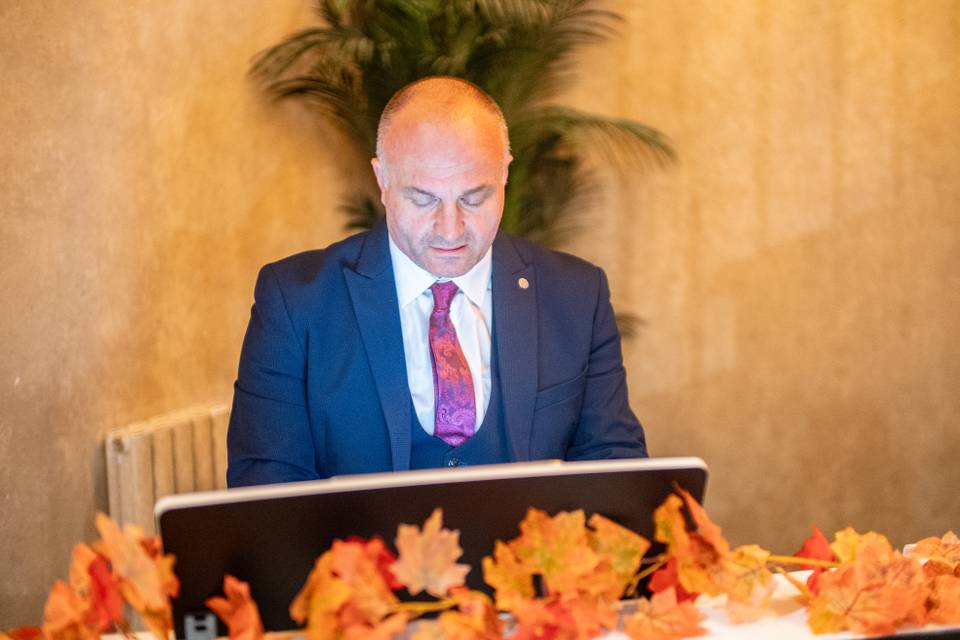 speaker at reception lectern with autumn leaves