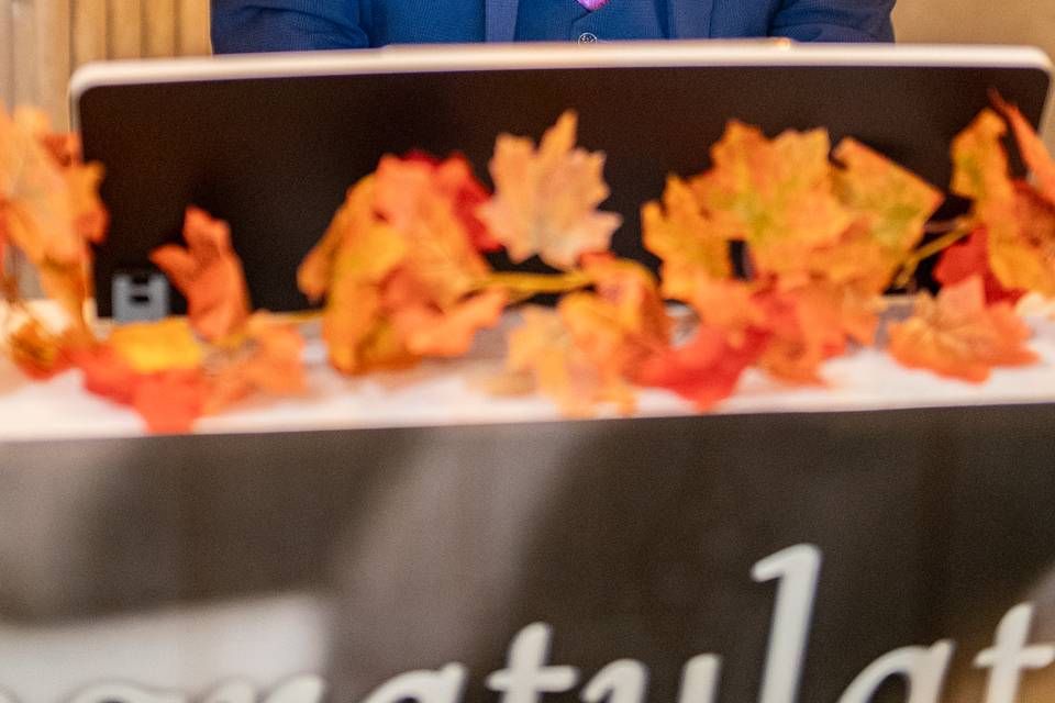 speaker in suit delivering toast at reception dais