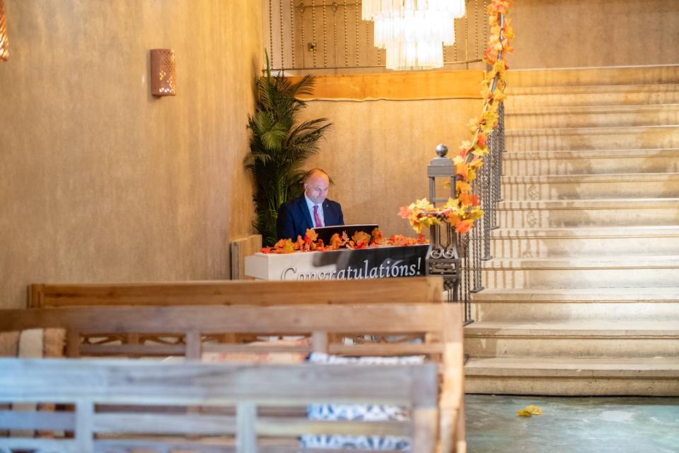 wide interior reception hall with staircase and piano