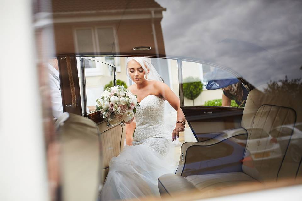 Bride getting in car