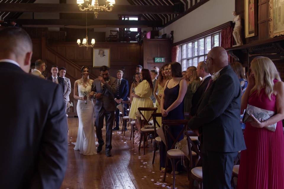 Manisha walks down the aisle.